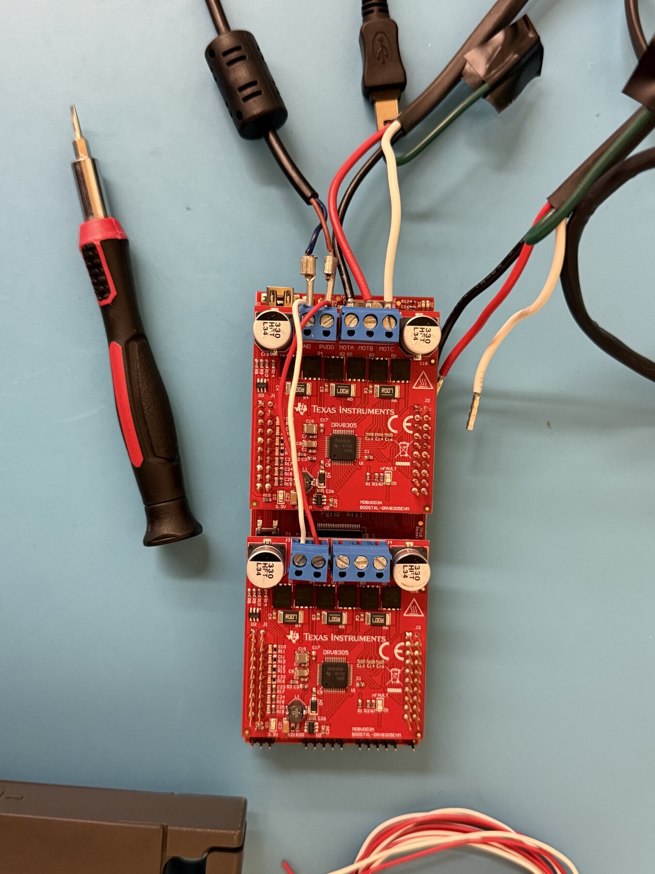 TI C2000 actuator controller board connected to bench wiring and test equipment